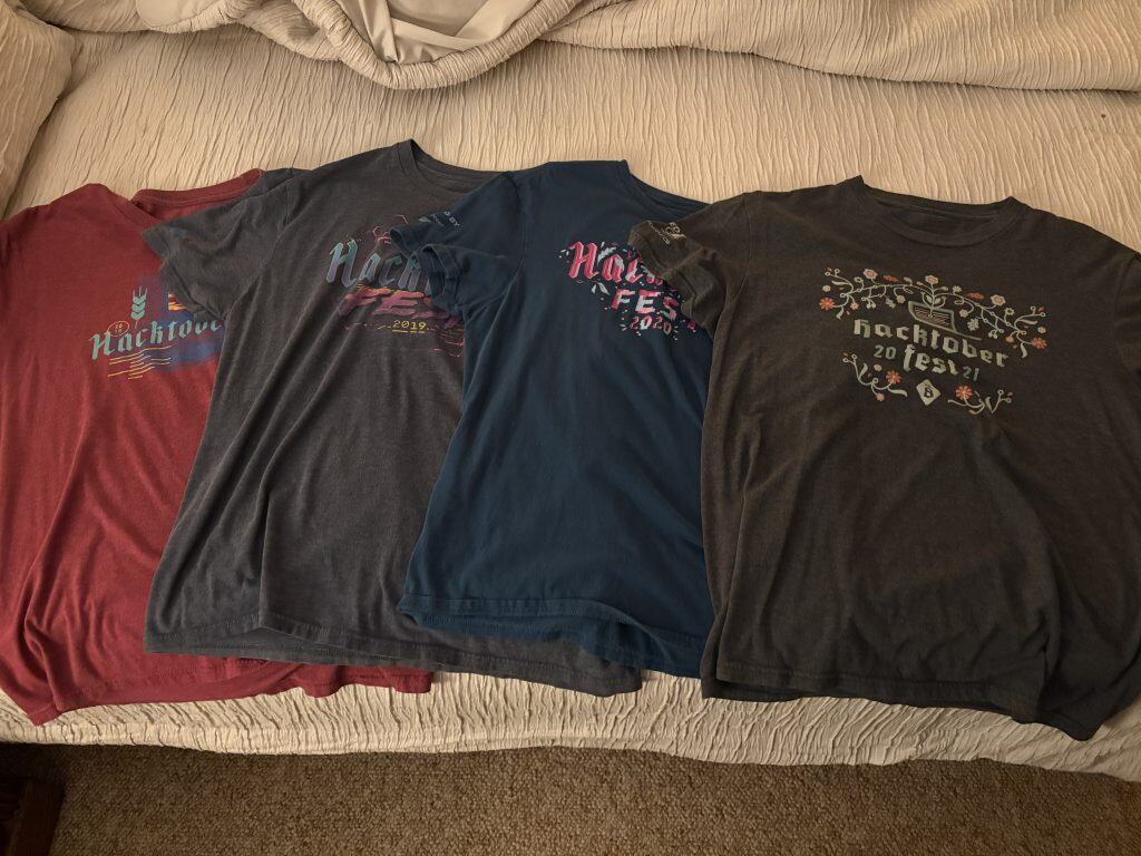 A photo of the Hacktoberfest T-Shirts from 2018 to 2021